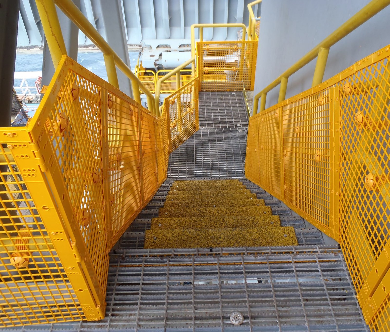 Yellow industrial stairway with BLH-DOM barriers