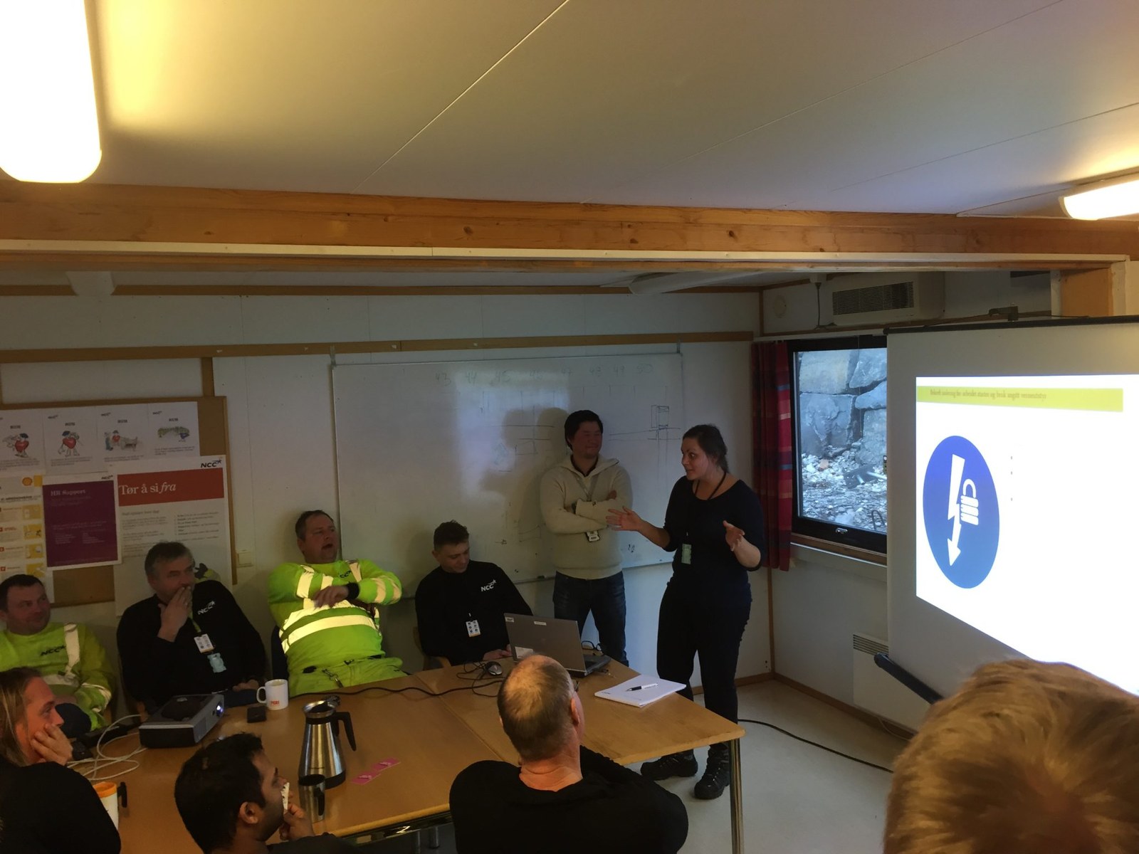 Specialist personnel attending a safety briefing in a project environment
